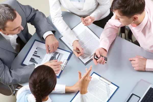 Beverage regulatory compliance experts reviewing international documentation